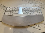 Matias FK413D Sculpted Ergonomic Rechargeable Keyboard. Open Box. $120 Retail. Price: $75.00.